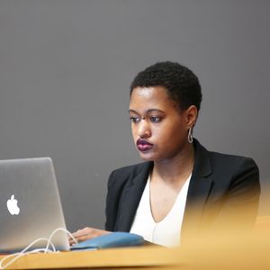 A woman works on her laptop