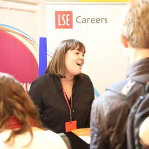 A Careers staff member talks to students at an event