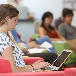 A student working on her laptop on campus
